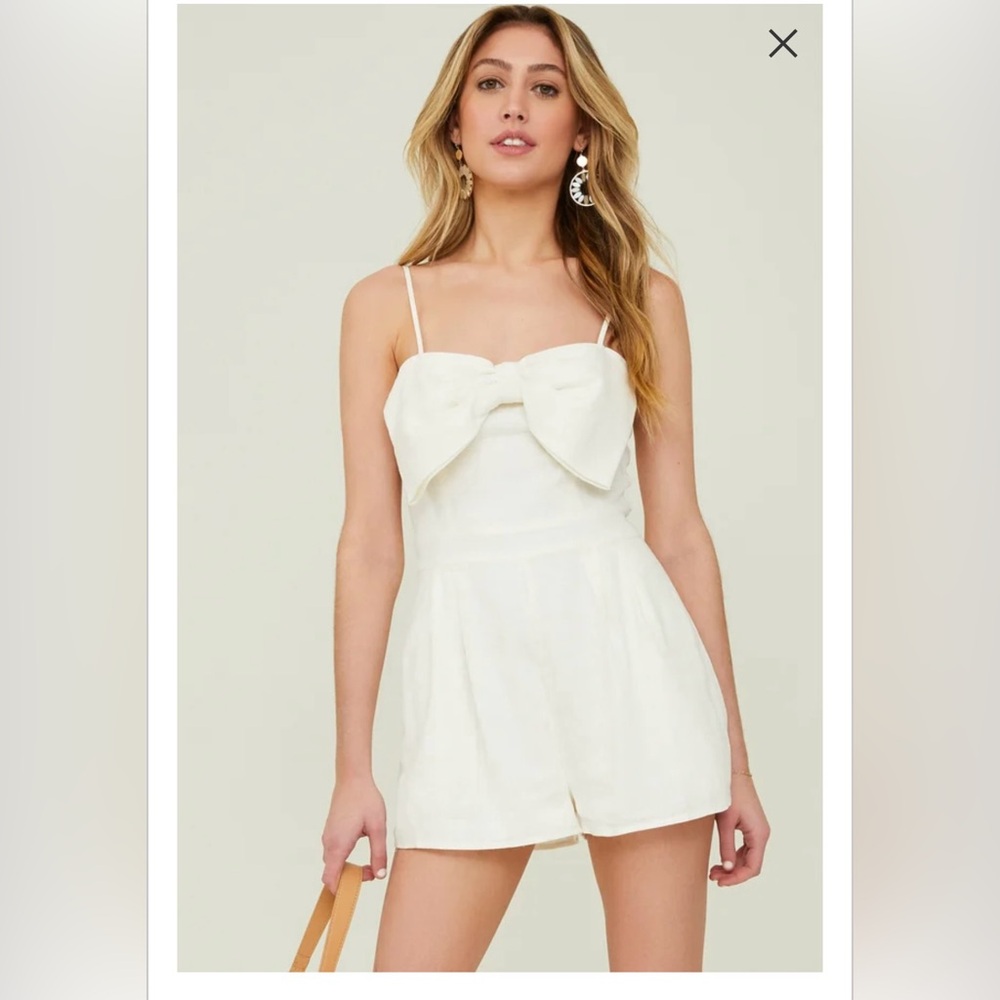 Ivory linen romper with bow from Altar’d State